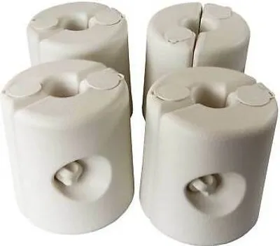 Four white plastic weights for a gazebo or tent.