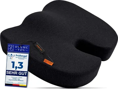 A black ergonomic seat cushion is shown on a white background with attached tags.
