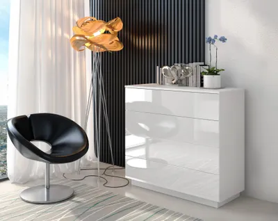 A modern living room scene featuring a white chest of drawers, a black accent chair, and a unique floor lamp.