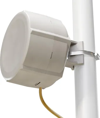 A white outdoor wireless access point is mounted on a white pole with a yellow cable attached.