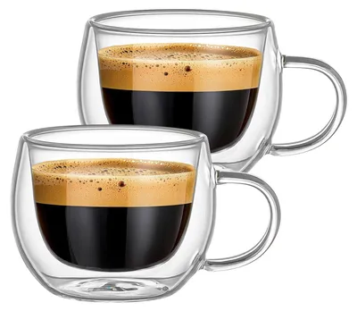 Two clear glass cups filled with espresso coffee and topped with crema, presented against a white background.