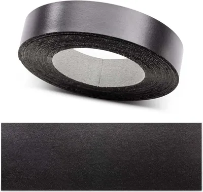 A roll of black tape against a white background, with a close-up of the tape texture below.