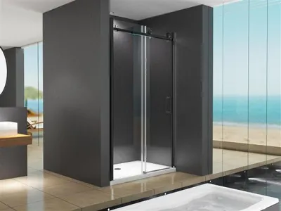 A modern bathroom with a shower enclosure overlooking the ocean.