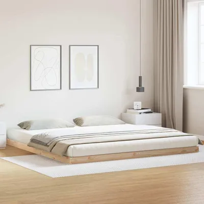 A bedroom scene with a bed frame and mattress.