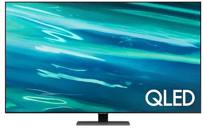 A Samsung QLED smart TV is displayed on its stand against a black background.