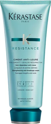 A product shot of a tube of hair treatment cream.