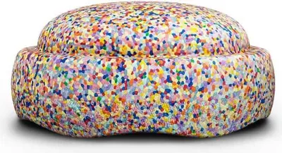 A colorful, round beanbag-like object with a speckled pattern.