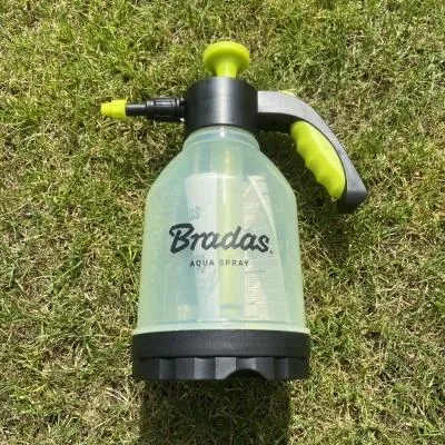A plant sprayer on grass.