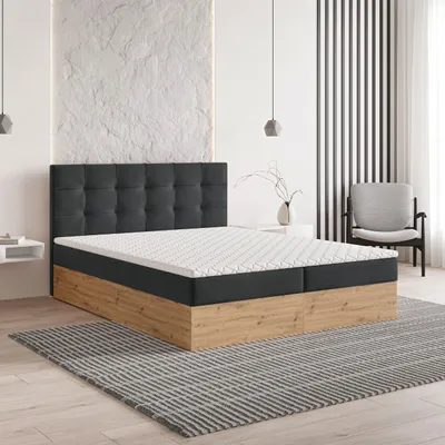 A modern bedroom setting with a boxspring bed as the main focus.