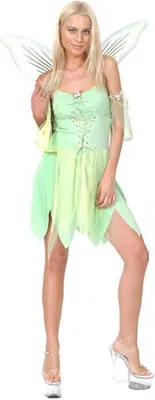 A woman in a green fairy costume with wings, standing against a white background.