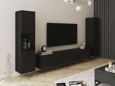 A modern living room setup with a black TV stand, a large black TV, and a tall black cabinet.
