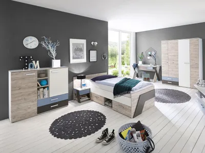 A modern bedroom set featuring a bed, dresser, nightstand, and wardrobe against a dark gray wall and white floor.