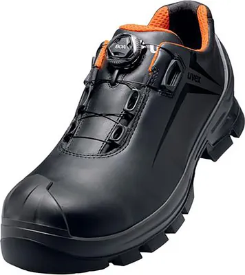 A single black and orange safety shoe is shown against a white background.