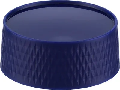 A blue bowl with a textured exterior and a smooth interior filled with a dark liquid.