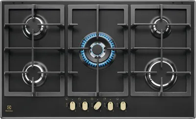 A top-down view of a black gas stove with five burners, one of which is lit with a blue flame.