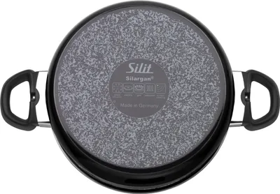 The bottom of a black pot with a speckled gray base and two black handles.