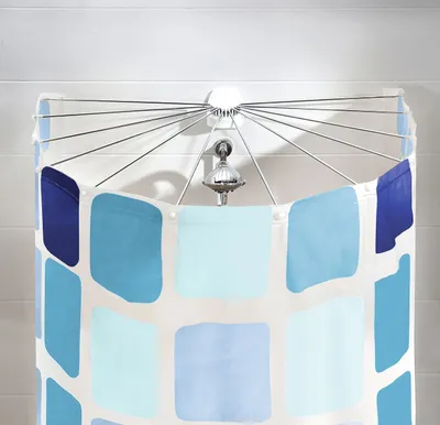 A shower curtain with a blue and white square pattern is shown hanging from a shower rod.