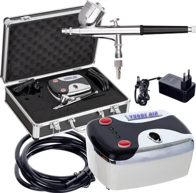 A collection of airbrushing equipment including a compressor, airbrush gun, hose, and power adapter, neatly arranged and presented against a white background.