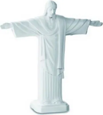 A white statue of Jesus Christ with arms outstretched, standing on a base.