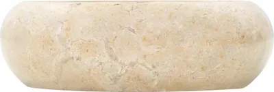 A close-up, side view of a cream-colored marble washbasin against a white background.
