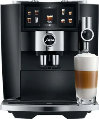 A JURA coffee machine is shown with a latte being dispensed into a glass.