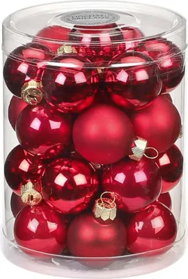 A clear, close-up view of a clear plastic container filled with red Christmas ornaments.