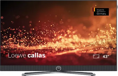 A Loewe callas 43 inch television displaying a vibrant, abstract image with bokeh effects. The TV is shown from the front, with its stand visible.