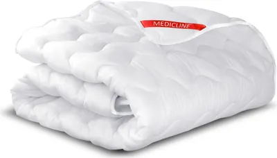 A folded white duvet with a red label.