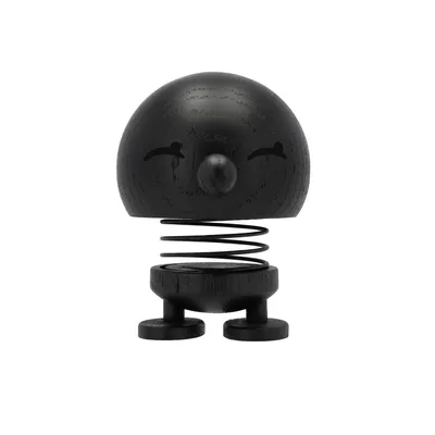 A black wooden Hoptimist figure with a springy body and a smiling face, shown from the front against a white background.