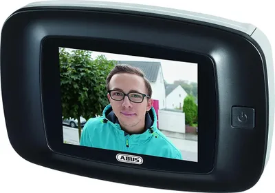 A digital door viewer showing a person's face on its screen.