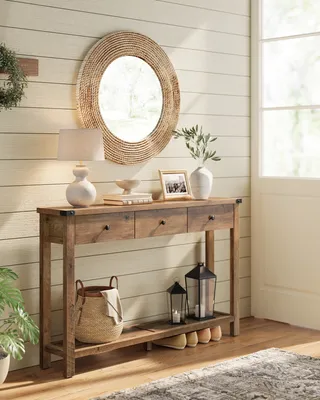 A console table with decorative items in a hallway.