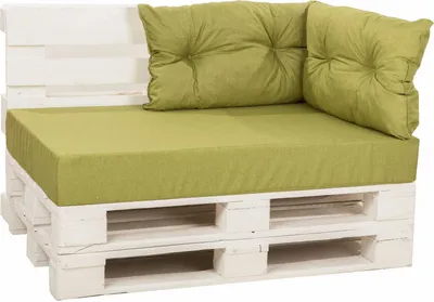 A white pallet sofa with green cushions.