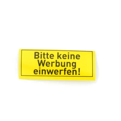 A yellow sticker with black text on a white background.