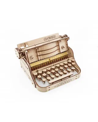 A wooden model of a typewriter is shown against a white background.