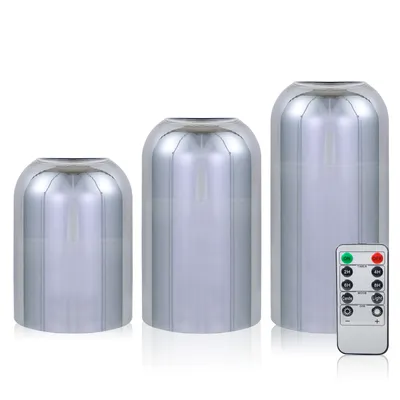 Three LED candles of varying sizes are displayed on a white background, with a remote control in the foreground.