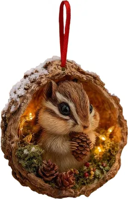 A decorative Christmas ornament featuring a chipmunk inside a hollowed-out nut shell, adorned with pinecones, moss, and small lights.