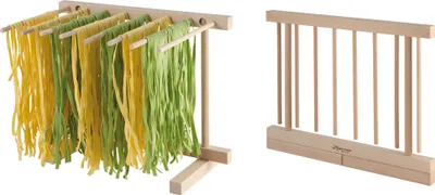 A wooden pasta drying rack with yellow and green pasta hanging on it, and a separate wooden pasta rack.