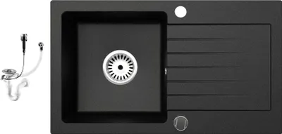 A black granite kitchen sink with a drainboard and a separate siphon set.