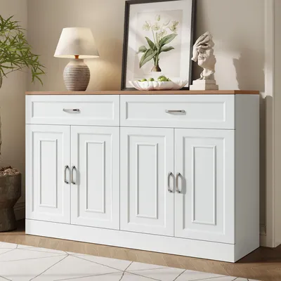 A white sideboard with wood grain top, decorated with a lamp, a framed picture, and a bust.