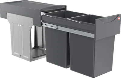 A built-in waste bin system with two compartments, shown pulled out from its cabinet.