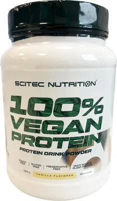 A white plastic container of protein powder with green and white labeling.