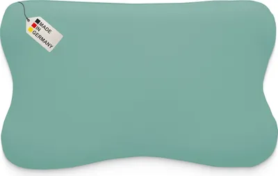 A teal-colored pillow with a tag that says 'Made in Germany'.