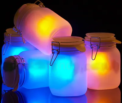 Several frosted glass jars with flip-top lids are illuminated from within by colorful LED lights, creating a magical and ambient glow.