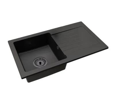 A black kitchen sink with a drainboard, shown from a diagonal angle against a white background.