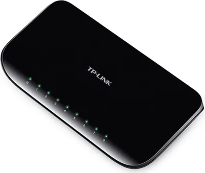 A black TP-Link network switch with multiple green indicator lights.