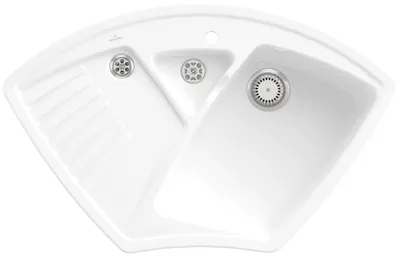 A top-down view of a white ceramic corner sink with multiple basins and a drain.