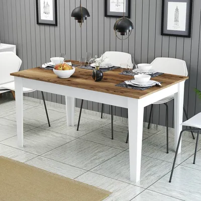 A dining table set in a modern dining room with chairs, tableware, and decorative items.