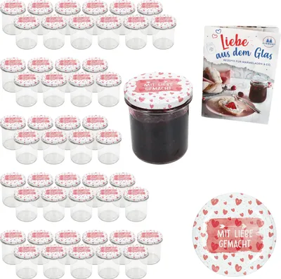 A collection of empty glass jars with decorative lids, one filled jar of jam, and a recipe booklet.