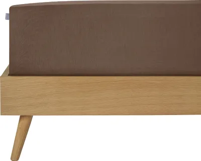 A close-up view of a bed frame with a brown fitted sheet.