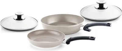 Two Fissler Ceratal pans with glass lids and black handles are arranged on a white background.